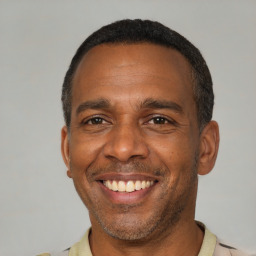 Joyful latino adult male with short  black hair and brown eyes