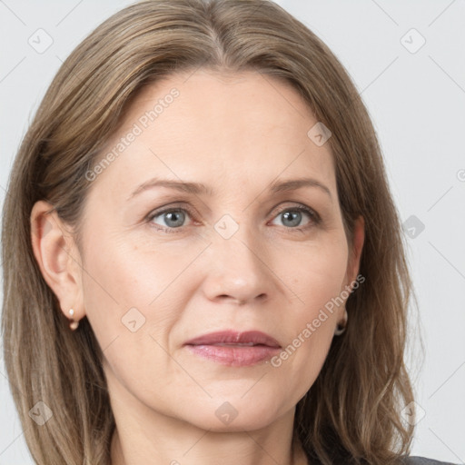 Joyful white adult female with long  brown hair and grey eyes