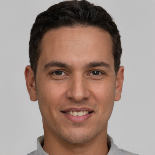 Joyful white young-adult male with short  brown hair and brown eyes