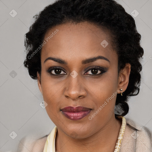 Joyful black young-adult female with long  black hair and brown eyes