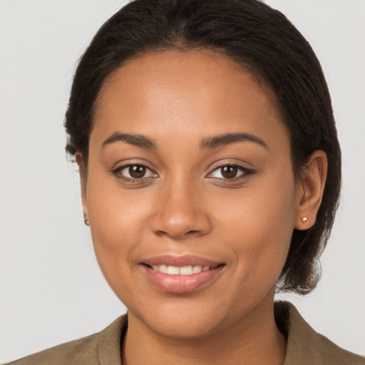 Joyful latino young-adult female with long  brown hair and brown eyes