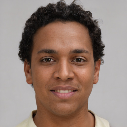 Joyful latino young-adult male with short  brown hair and brown eyes
