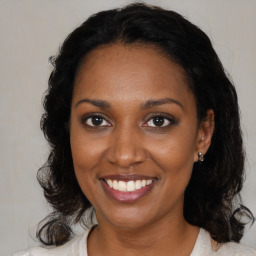 Joyful black young-adult female with medium  brown hair and brown eyes