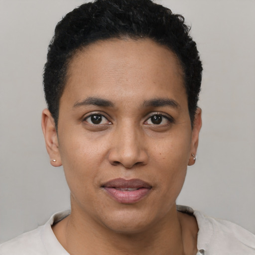 Joyful latino young-adult female with short  black hair and brown eyes
