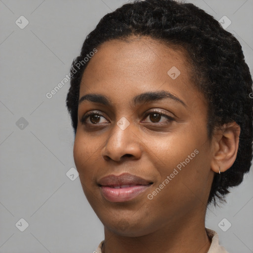 Joyful black young-adult female with short  black hair and brown eyes