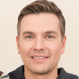 Joyful white young-adult male with short  brown hair and grey eyes