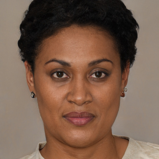 Joyful latino adult female with short  brown hair and brown eyes