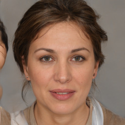 Joyful white adult female with medium  brown hair and brown eyes