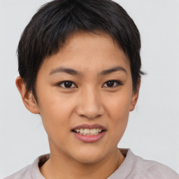 Joyful asian young-adult female with short  brown hair and brown eyes