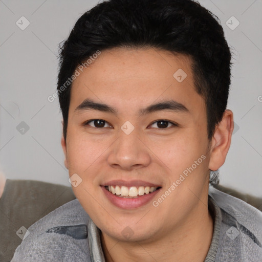 Joyful asian young-adult male with short  black hair and brown eyes