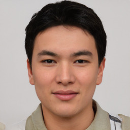 Joyful asian young-adult male with short  black hair and brown eyes