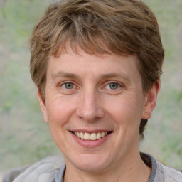 Joyful white adult female with short  brown hair and grey eyes