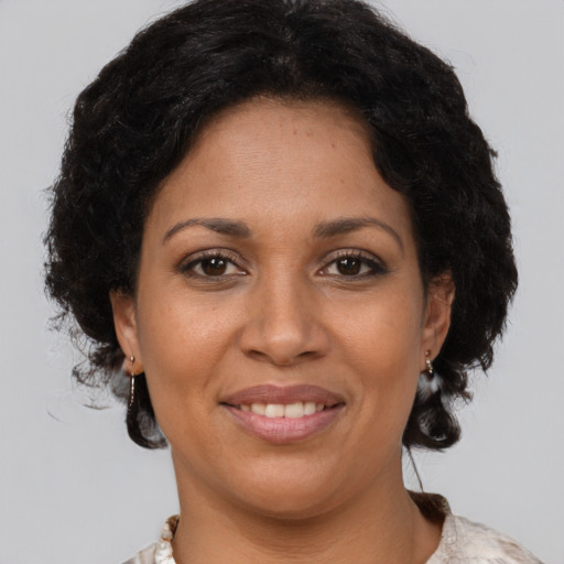 Joyful latino adult female with short  brown hair and brown eyes