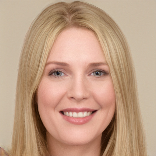 Joyful white young-adult female with long  blond hair and blue eyes