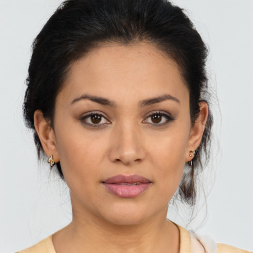 Joyful latino young-adult female with medium  brown hair and brown eyes