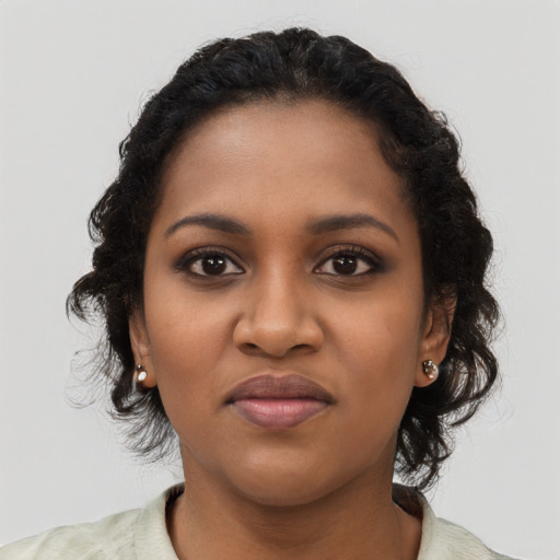 Joyful black young-adult female with medium  brown hair and brown eyes