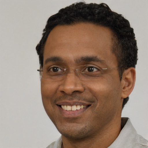 Joyful black young-adult male with short  black hair and brown eyes