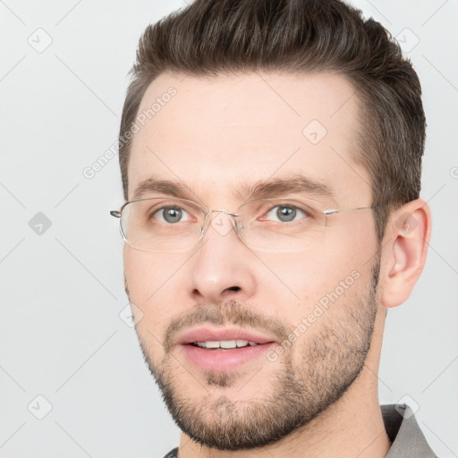 Joyful white adult male with short  brown hair and brown eyes