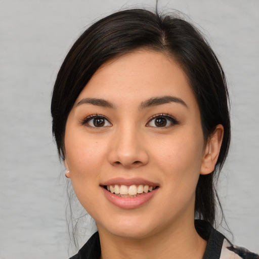 Joyful white young-adult female with medium  black hair and brown eyes