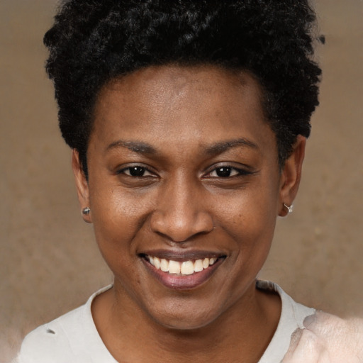 Joyful black young-adult female with short  black hair and brown eyes