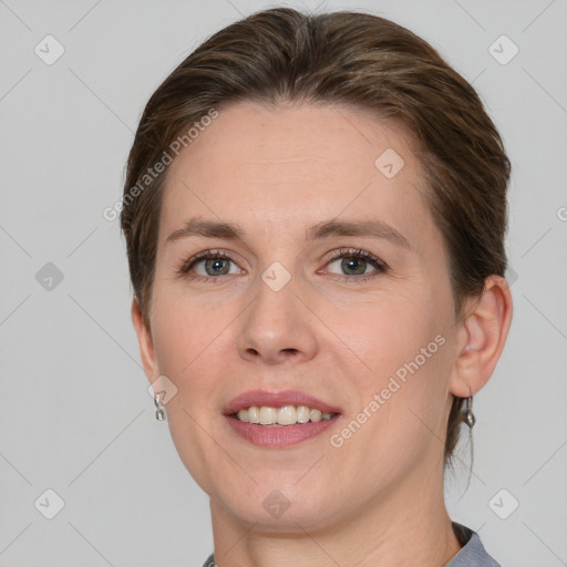 Joyful white young-adult female with short  brown hair and grey eyes