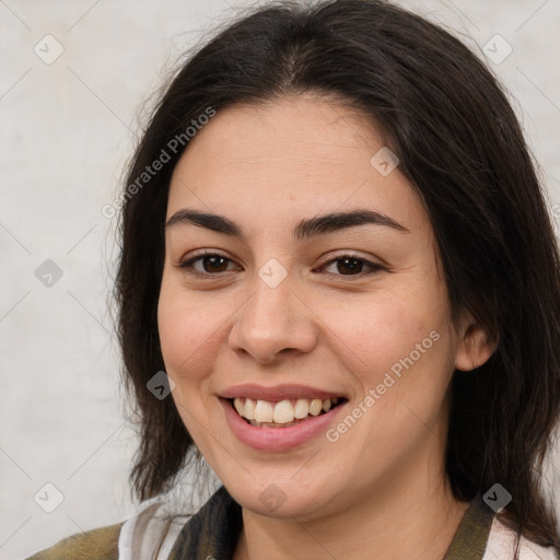 Joyful latino young-adult female with medium  brown hair and brown eyes