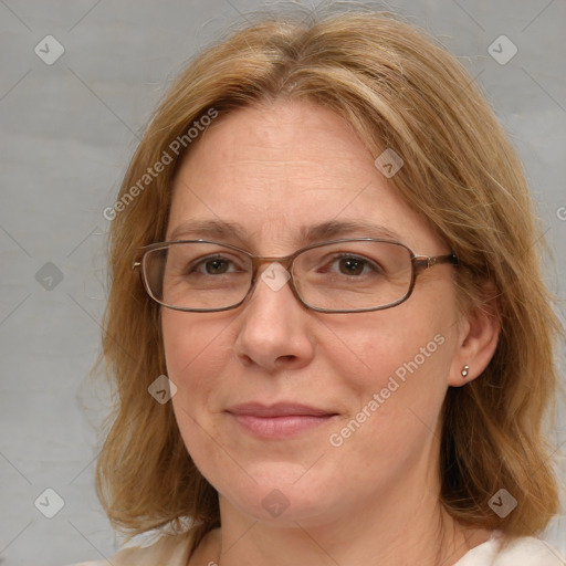 Joyful white adult female with medium  brown hair and blue eyes