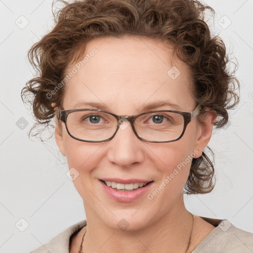 Joyful white adult female with medium  brown hair and blue eyes