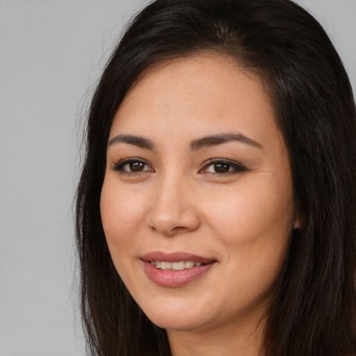 Joyful asian young-adult female with long  brown hair and brown eyes