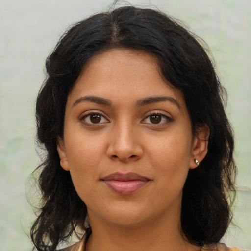 Joyful latino young-adult female with medium  brown hair and brown eyes