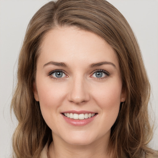 Joyful white young-adult female with medium  brown hair and green eyes