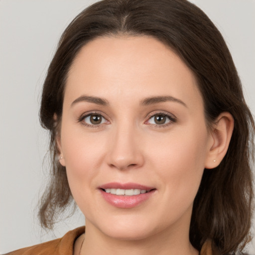 Joyful white young-adult female with medium  brown hair and brown eyes