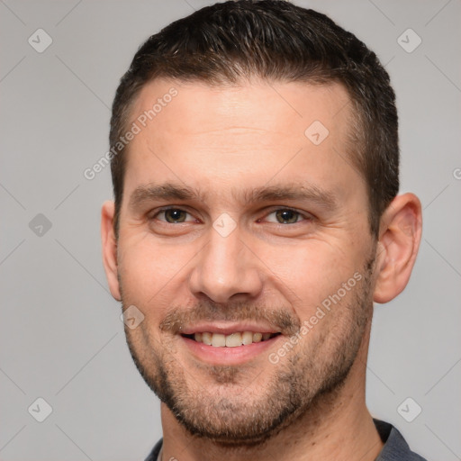 Joyful white adult male with short  brown hair and brown eyes