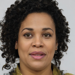 Joyful black adult female with medium  brown hair and brown eyes