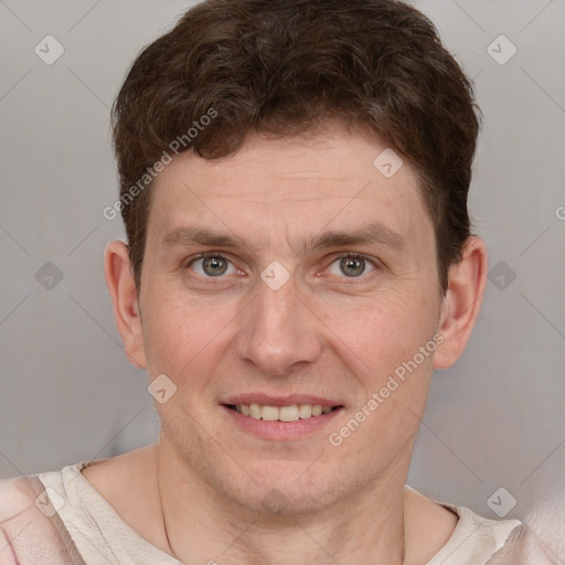 Joyful white adult male with short  brown hair and grey eyes