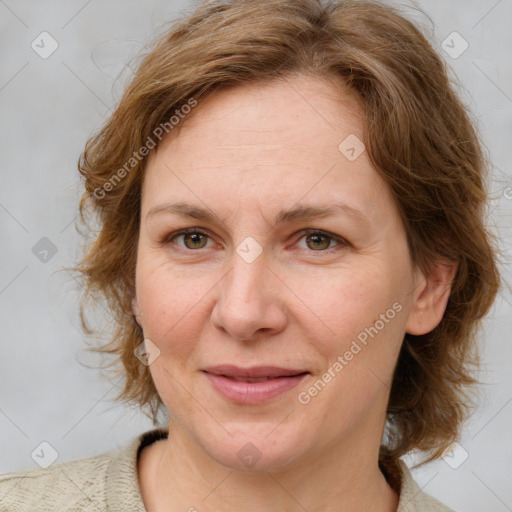 Joyful white adult female with medium  brown hair and blue eyes