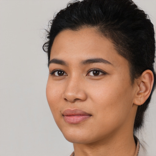 Joyful asian young-adult female with short  brown hair and brown eyes