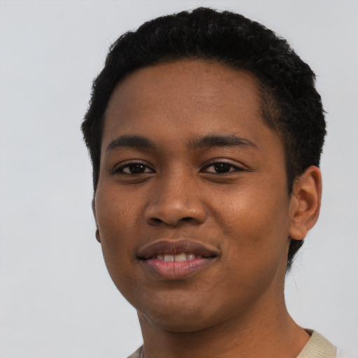 Joyful black young-adult male with short  black hair and brown eyes