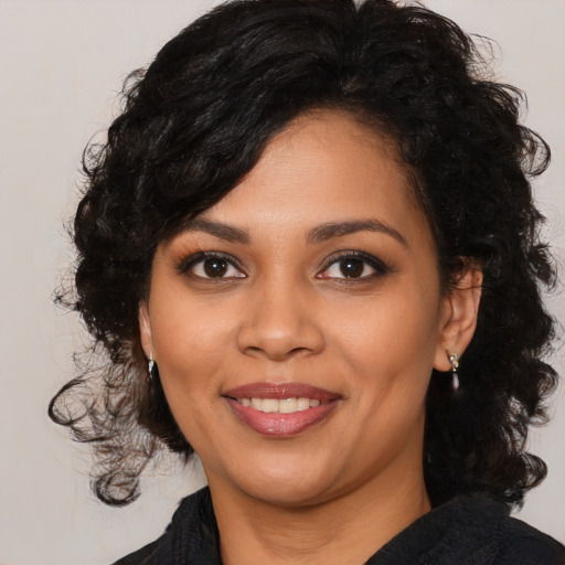 Joyful latino young-adult female with medium  black hair and brown eyes