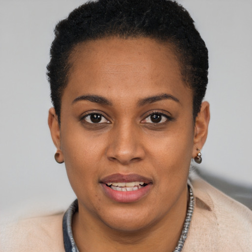 Joyful black young-adult female with short  brown hair and brown eyes