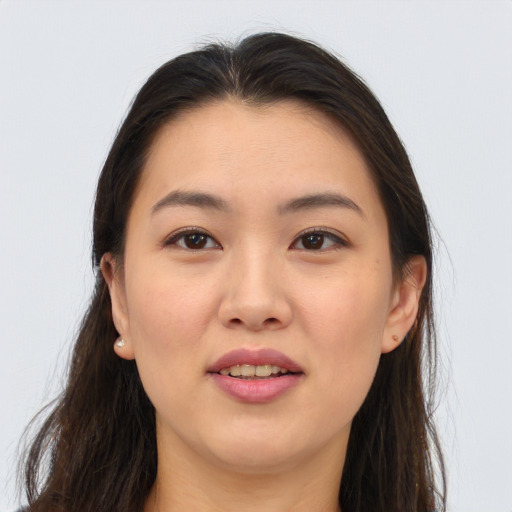 Joyful asian young-adult female with long  brown hair and brown eyes