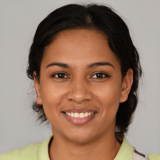 Joyful latino young-adult female with medium  brown hair and brown eyes