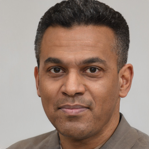Neutral latino adult male with short  black hair and brown eyes