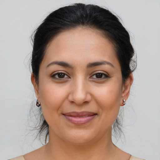 Joyful latino young-adult female with medium  brown hair and brown eyes