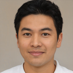 Joyful asian young-adult male with short  black hair and brown eyes