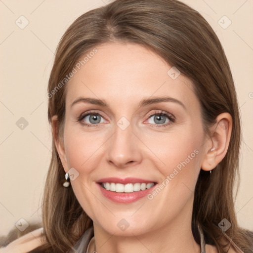 Joyful white young-adult female with long  brown hair and grey eyes