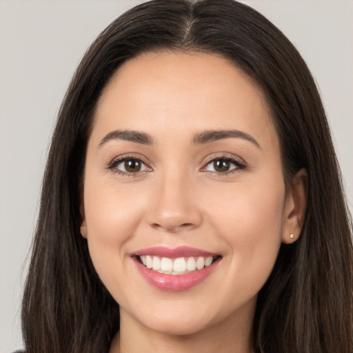 Joyful white young-adult female with long  brown hair and brown eyes