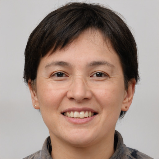 Joyful white adult female with short  brown hair and brown eyes
