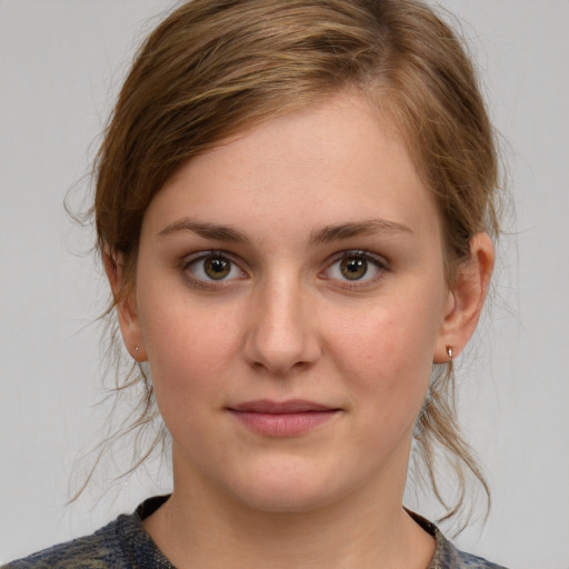 Joyful white young-adult female with medium  brown hair and blue eyes