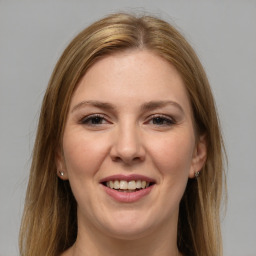 Joyful white young-adult female with long  brown hair and brown eyes